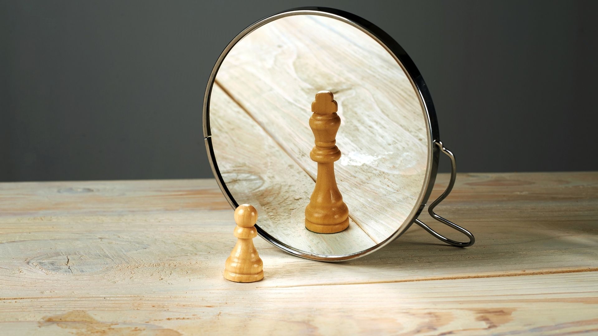 pieza peón de ajedrez mirándose al espejo reflejado como una reina